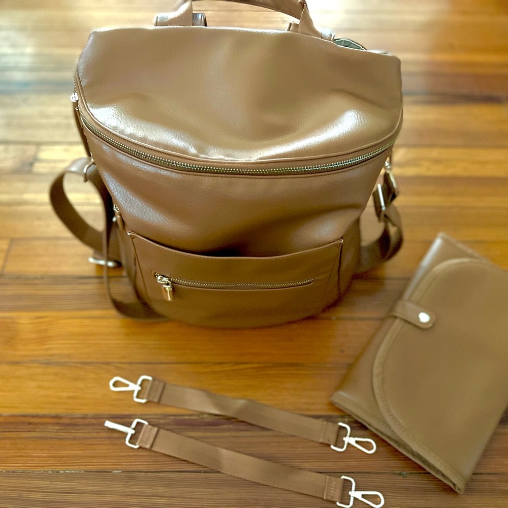 Brown leather diaper backpack.